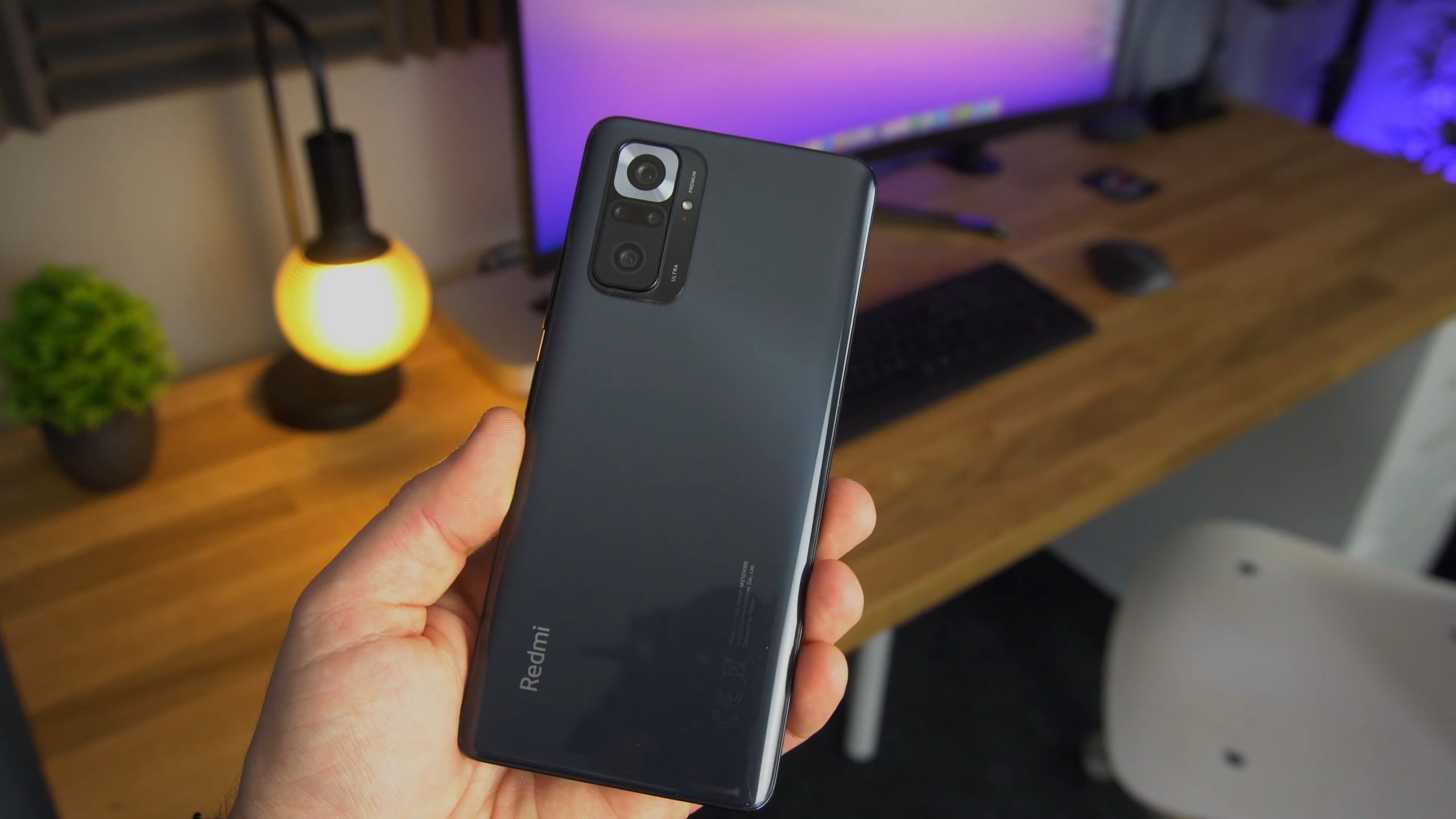 a smartphone (redmi 10 pro max) in hand